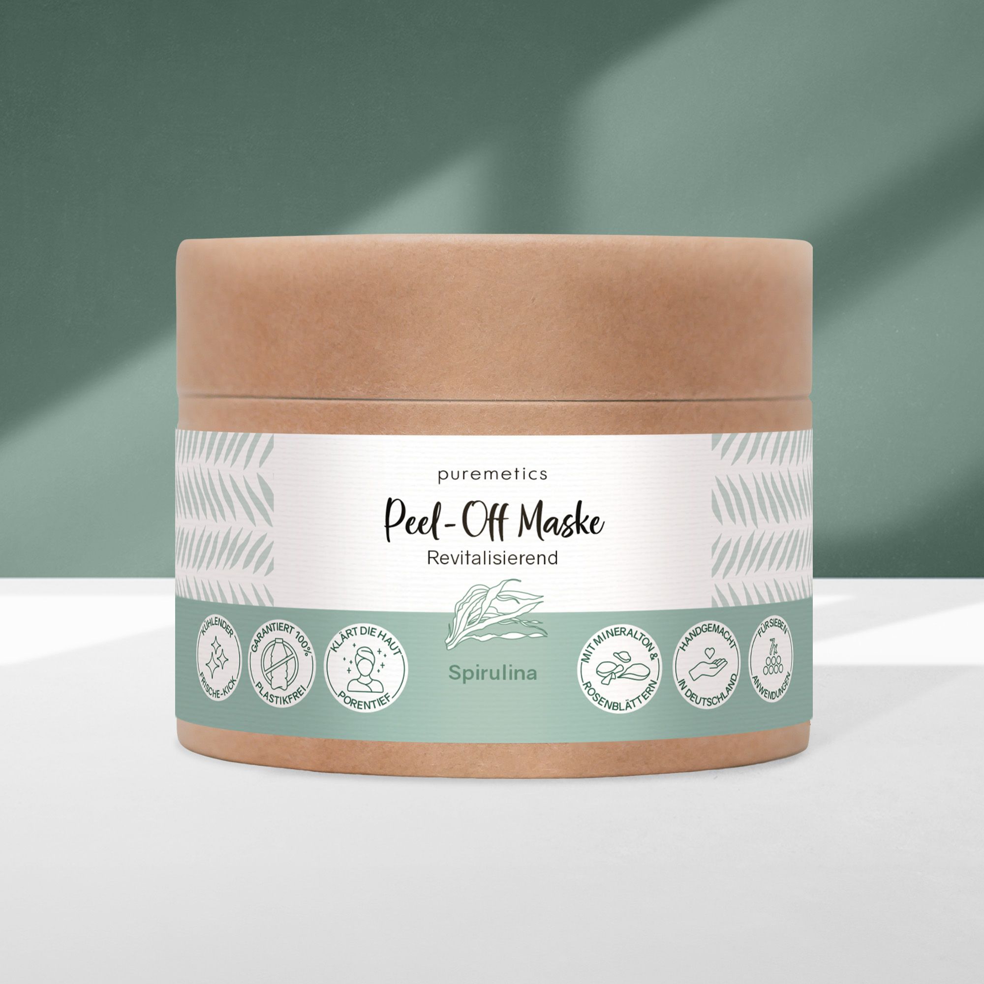 Confezione cilindrica 'puremetics Peel-Off Maske'. Scritta 'Anti-Unreinheiten: Spirulina'. Dettagli etichetta verde-bianco.