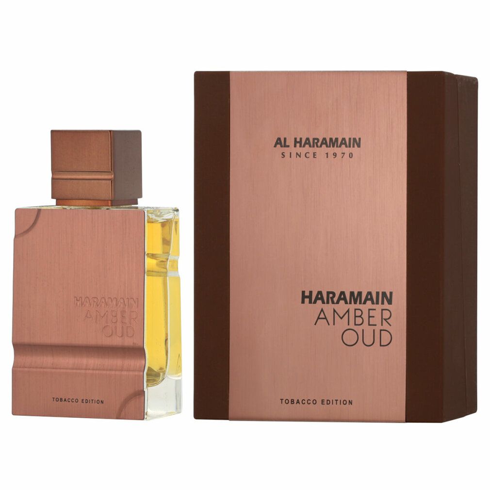 Flacone di profumo e confezione. Scritta: Al Haramain, Amber Oud Tobacco Edition. Flacone e scatola nei toni del marrone e dell'oro.