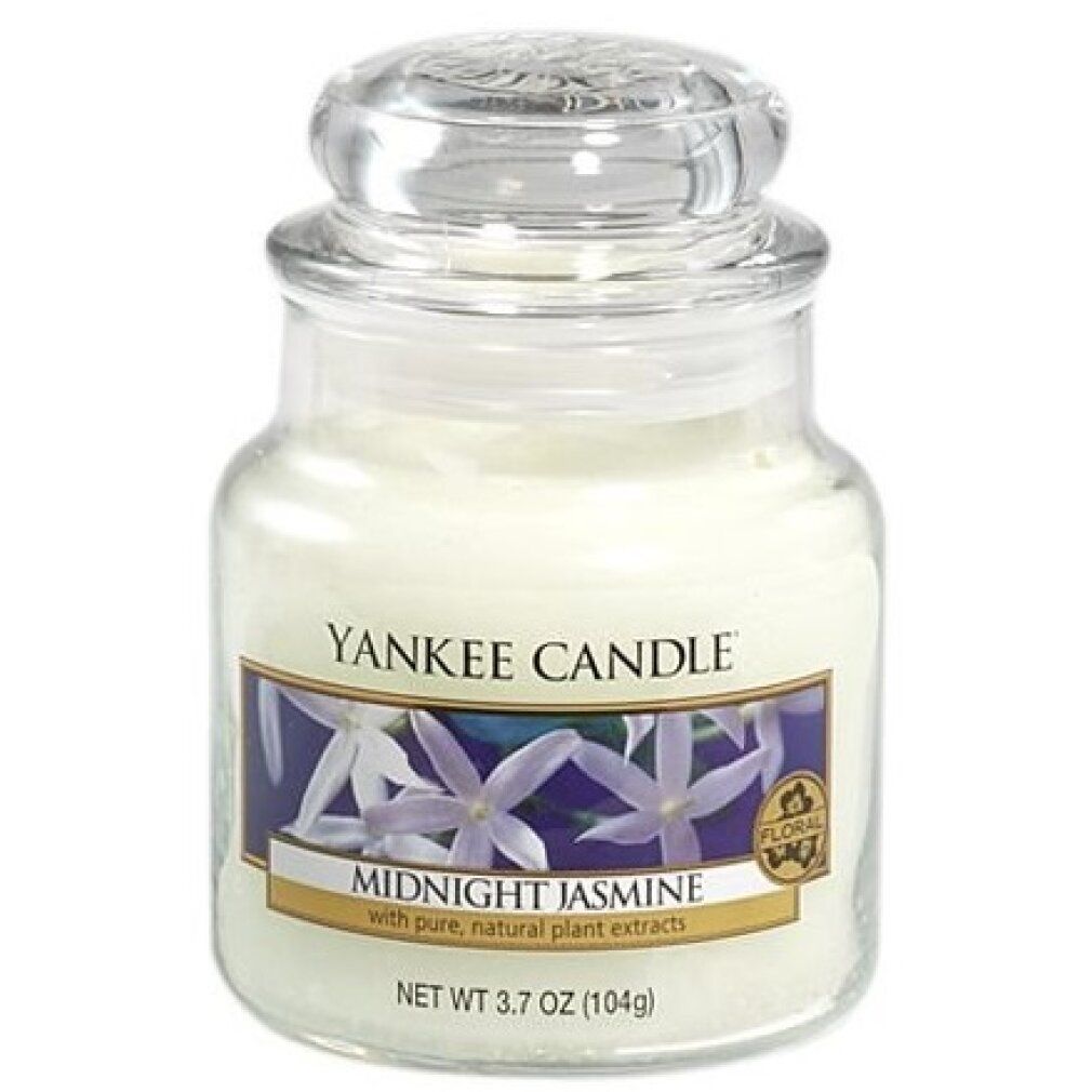 Candela profumata in vaso con coperchio. Etichetta con motivo floreale e scritta "Midnight Jasmine". Marchio: Yankee Candle. Sigillo: Floral.