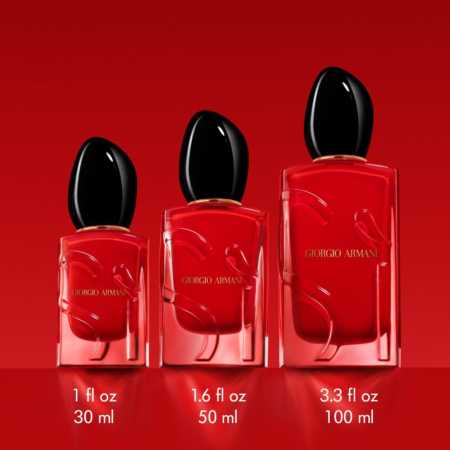 Tre flaconi rossi con tappo nero. Dimensioni: 1 fl oz 30 ml, 1.6 fl oz 50 ml, 3.3 fl oz 100 ml. Scritta: Giorgio Armani.