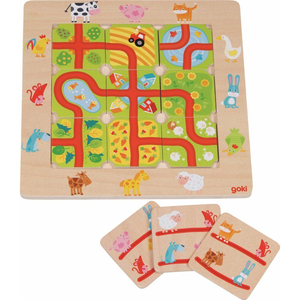 Puzzle in legno con animali e strade. Il tabellone è quadrato con pezzi di puzzle inseriti. Logo Goki in basso a destra.