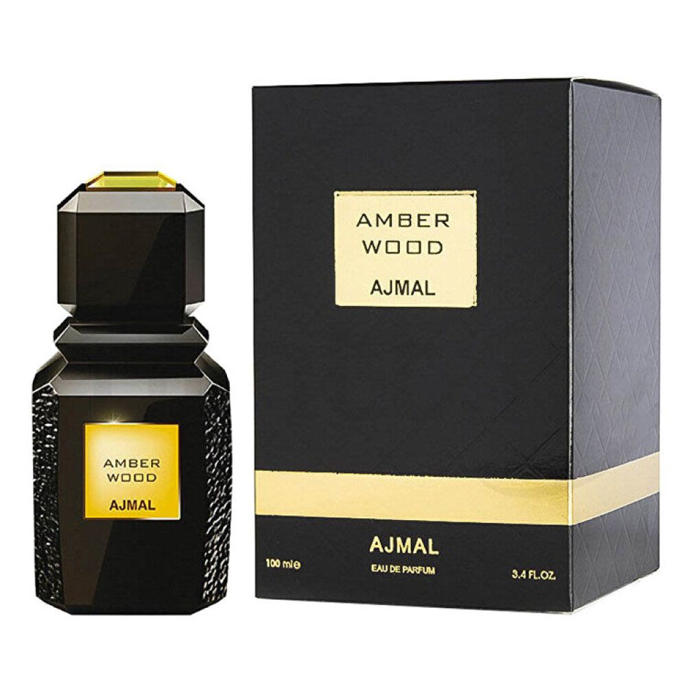 Flacone e scatola neri. Flacone con etichetta dorata AMBER WOOD e AJMAL. Scatola con scritta.