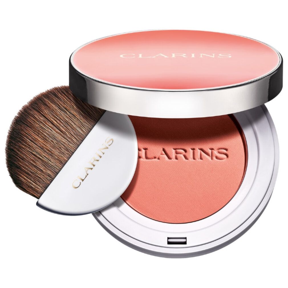 Contenitore di blush rotondo con pennello e applicatore. Coperchio con scritta Clarins. Fard color pesca.