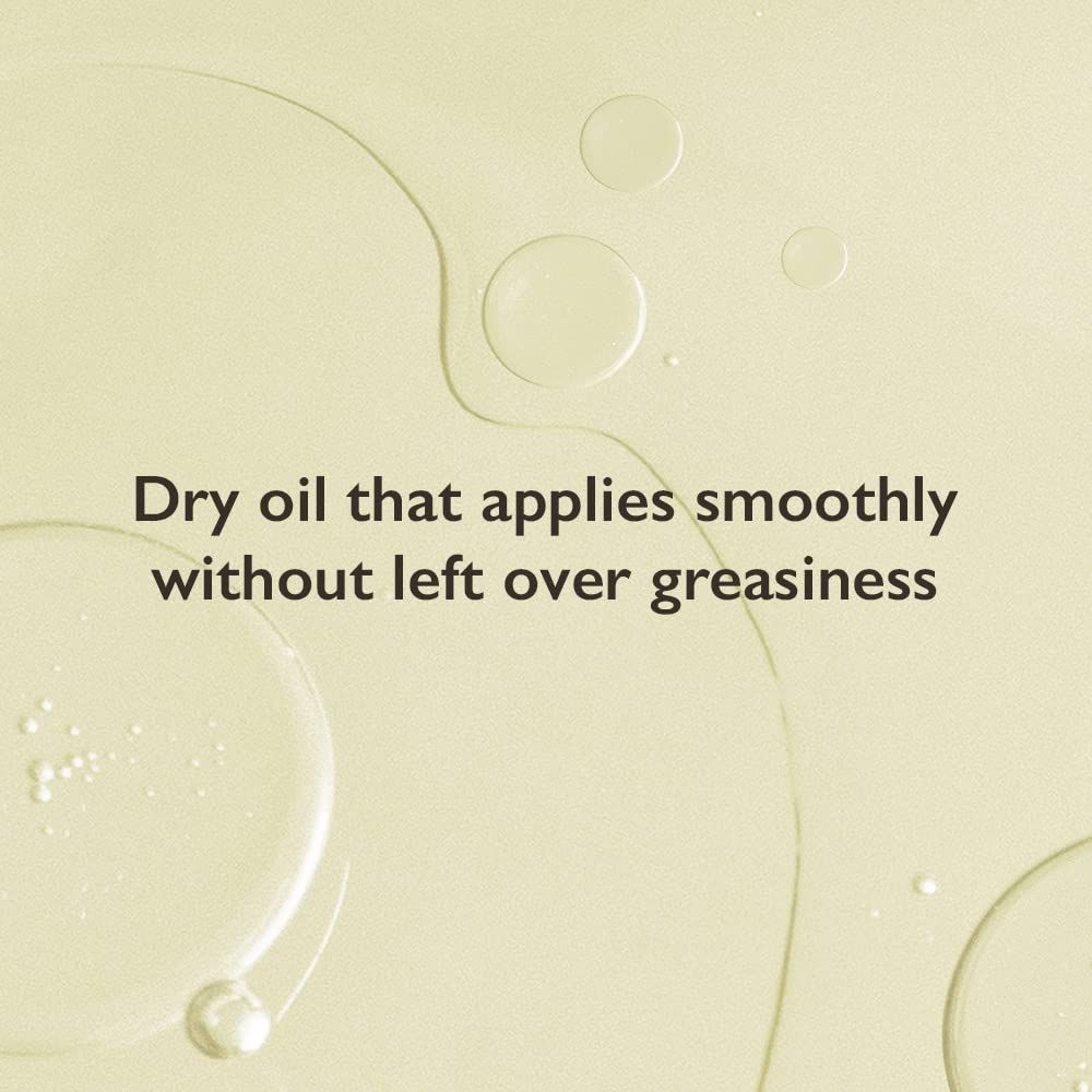 Primo piano di goccioline di olio. Testo: Olio secco che si applica delicatamente senza residui untuosi.