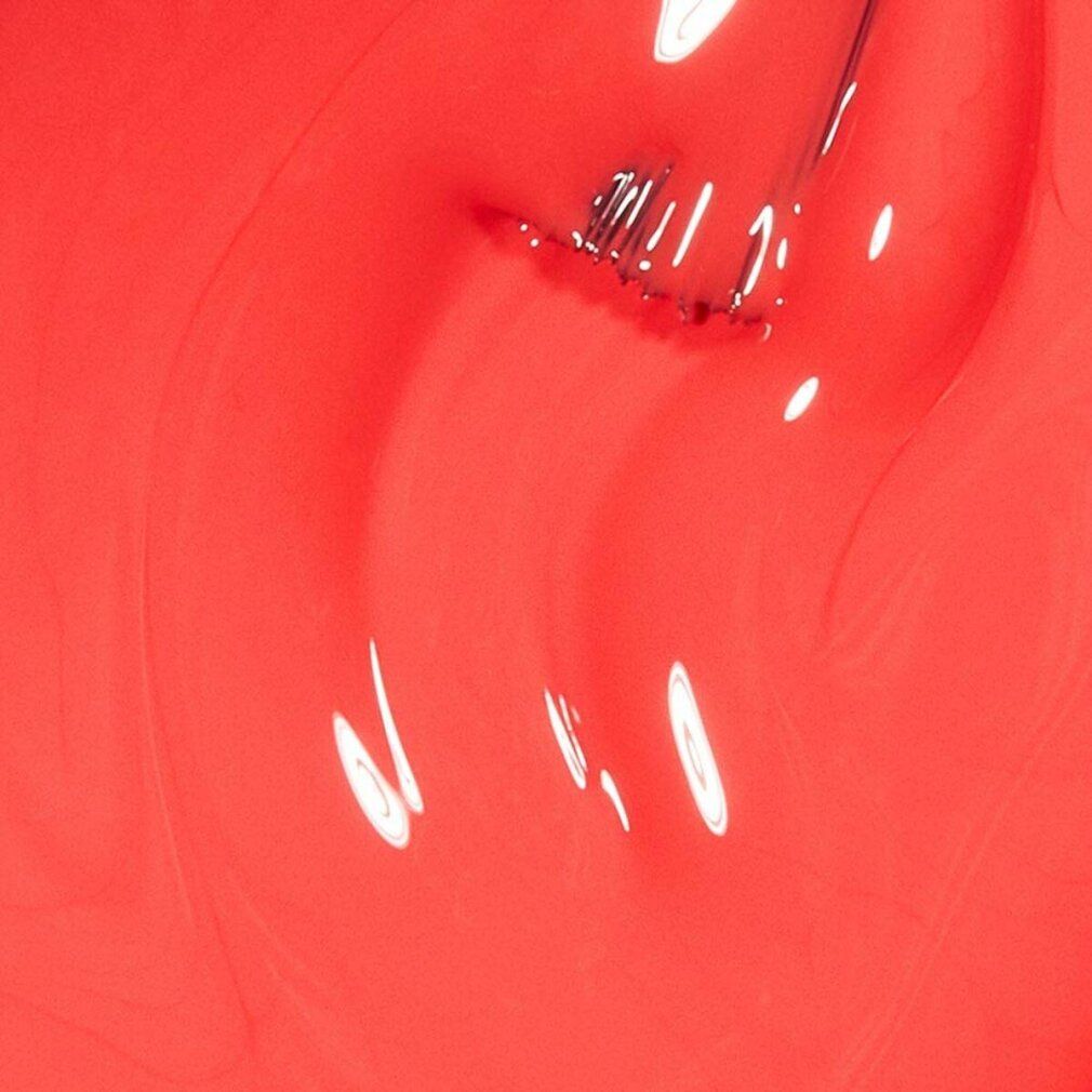 Primo piano di smalto rosso. Pennello e superficie dello smalto con riflessi.