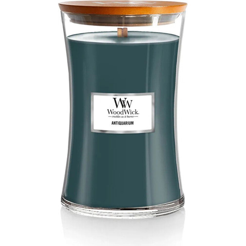 Candela "WoodWick Antiquarium" con stoppino in legno, cera verde-blu, contenitore in vetro, coperchio in legno. Etichetta.