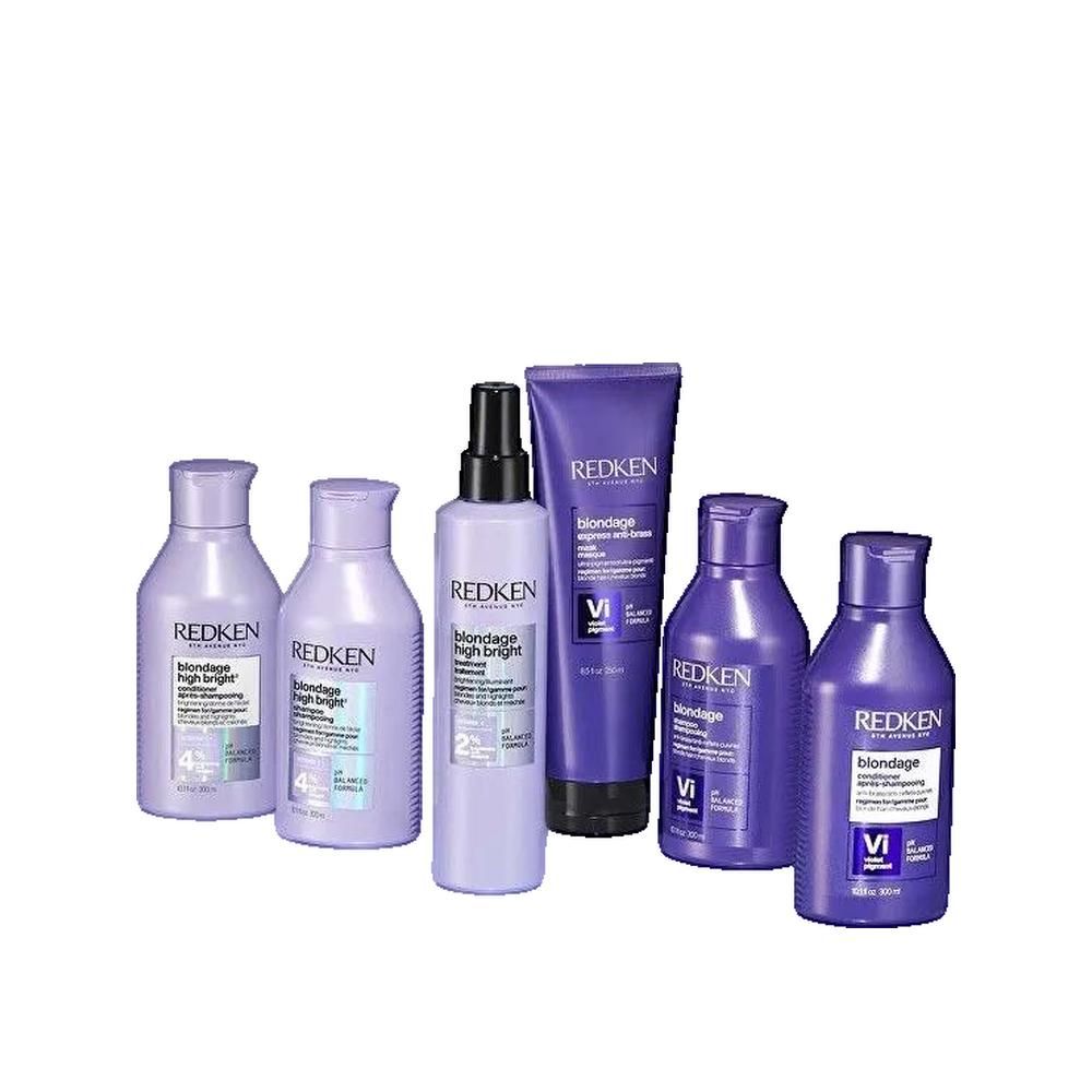 Diversi prodotti Redken Blondage High Bright. Flaconi e tubi viola. Testo: Blondage High Bright, Vitamina C, 2% e 4%, formula pH bilanciata.