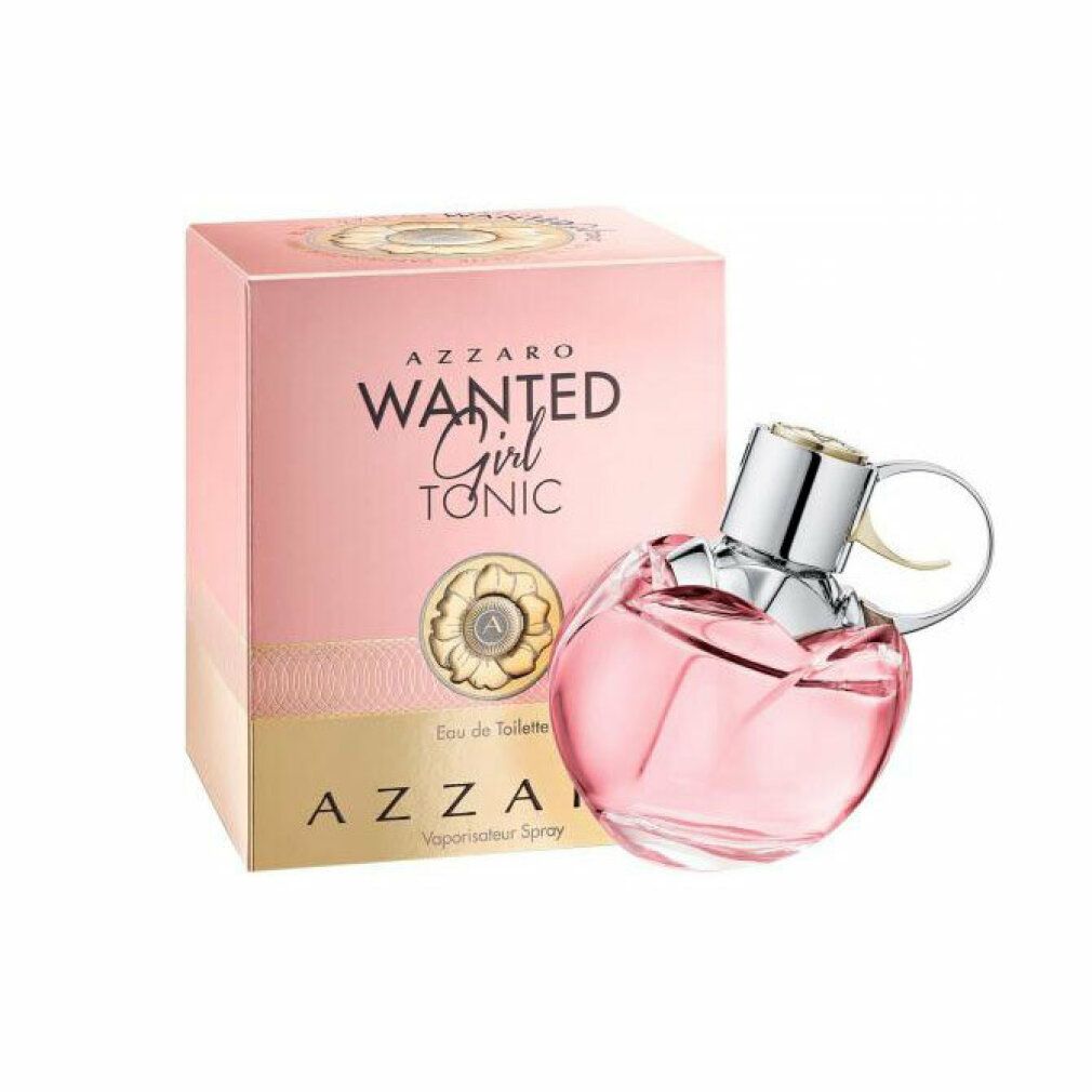 Azzaro Wanted Girl Tonic Eau De Toilette Spray. Flacone rosa a forma di granata, tappo argentato. Confezione rosa con nome del prodotto.