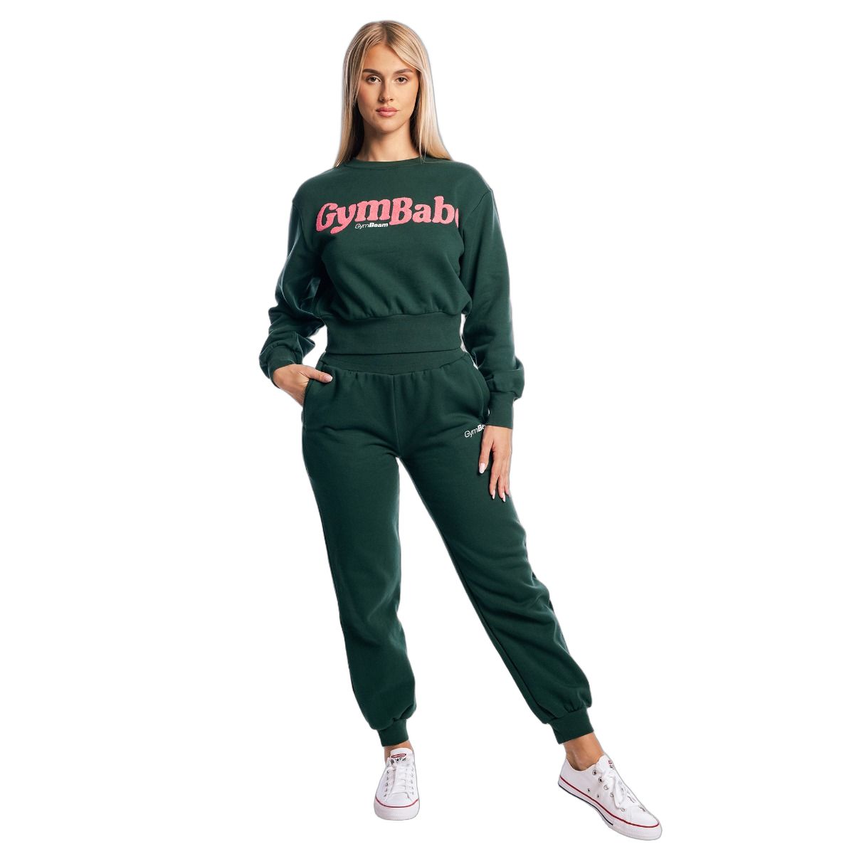 Vista a figura intera di una donna con completo verde: maglione cropped a maniche lunghe Forest e pantaloni della tuta.