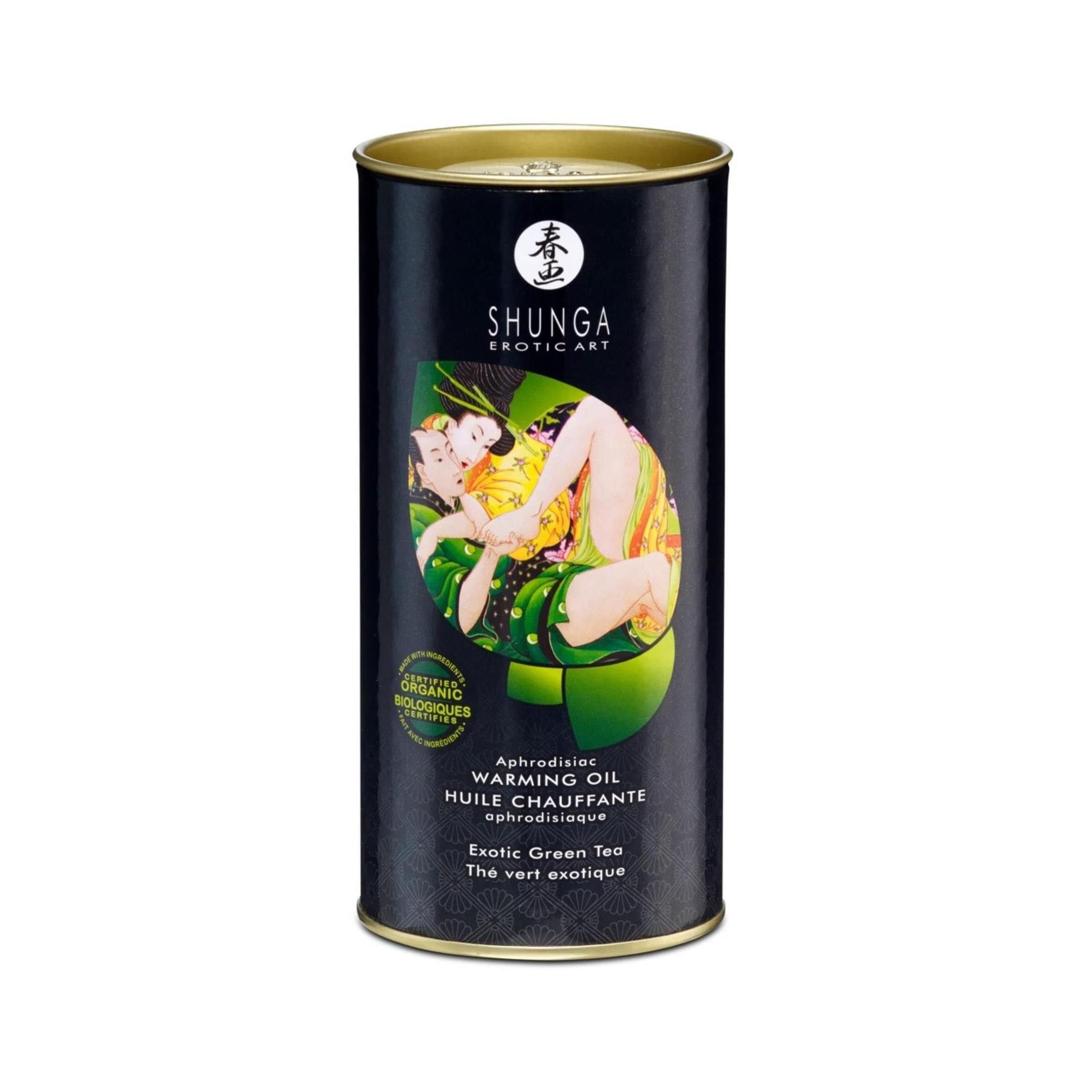 Confezione cilindrica con immagine. Scritta: SHUNGA, Exotic Art. Testo: Warming Oil, Afrodisiaco, Tè verde esotico.