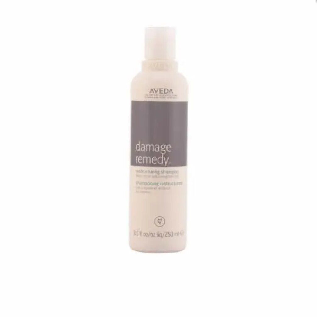Flacone di shampoo beige con etichetta grigia. Scritta: Aveda, Damage Remedy, Restructuring Shampoo. 250 ml.