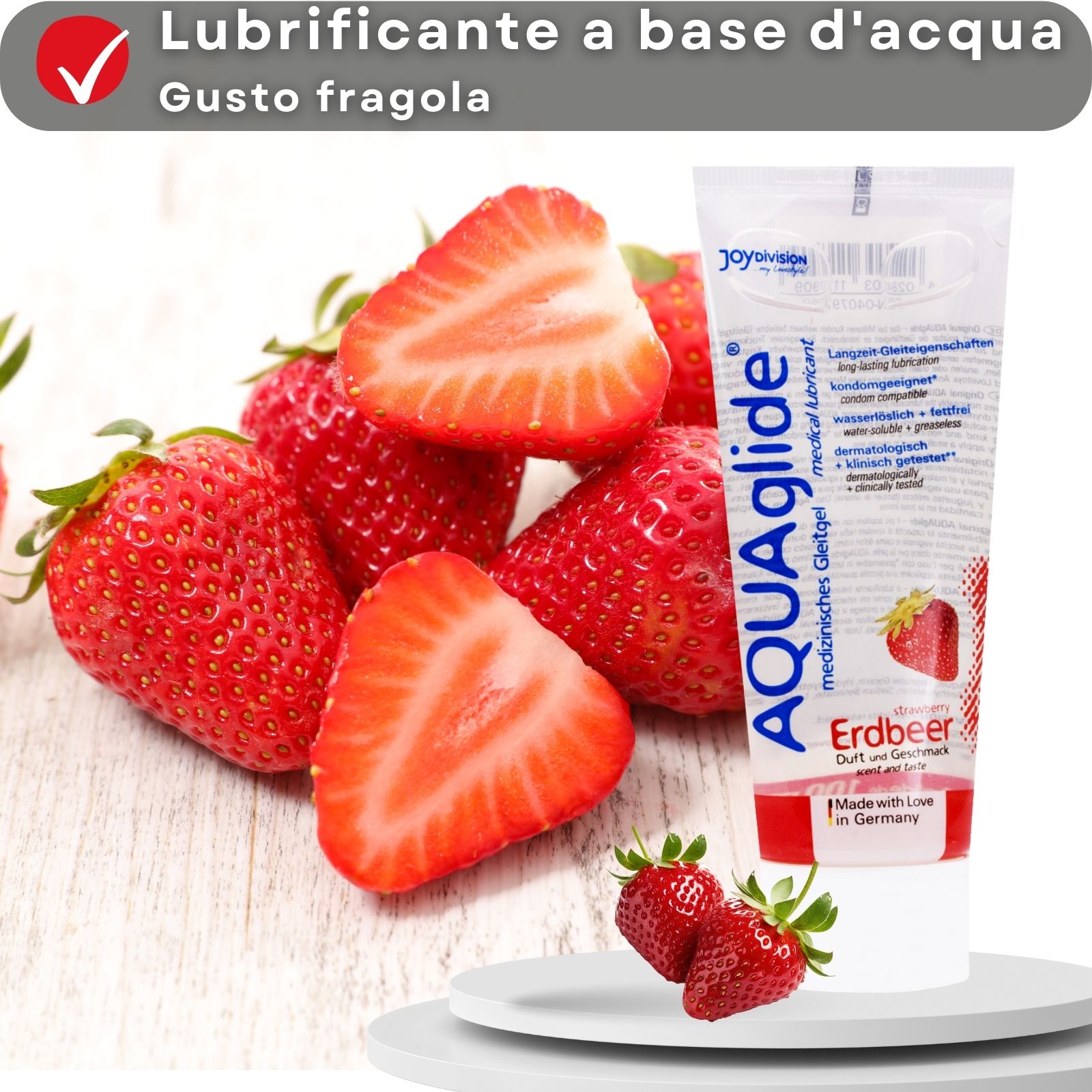 Tubo di gel AQUAglide fragola. Per pelli sensibili. Donna con fiore. Sfondo beige.