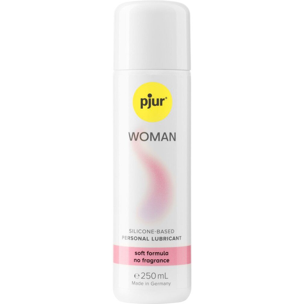 Flacone bianco con tappo bianco. Scritta: pjur WOMAN, con tratto ondulato rosa. Testo: soft formula no fragrance.