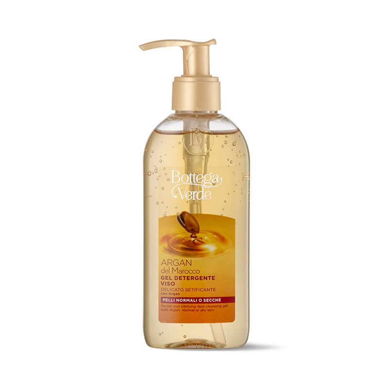 Flacone trasparente con dosatore dorato. Etichetta con nome prodotto e logo. Liquido visibile.