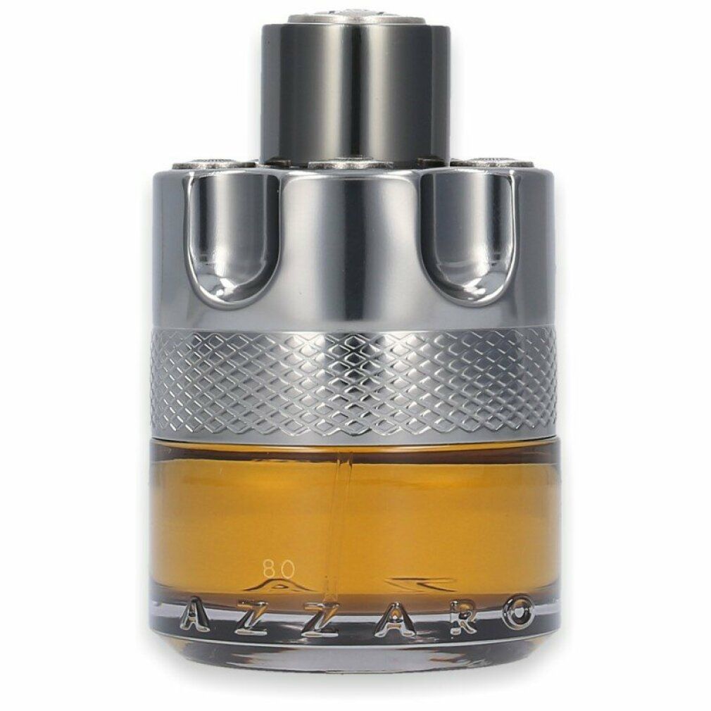 Azzaro Wanted by Night Eau de Parfum. Flacone cilindrico, tappo argentato, liquido dorato. Vista ravvicinata.