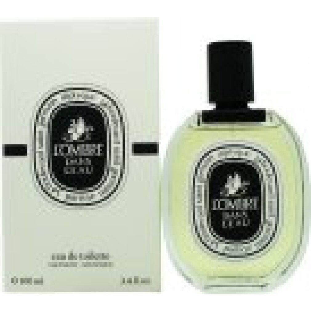 Flacone di profumo e confezione. Flacone ovale, trasparente, con tappo nero. Confezione bianca con etichetta nera. Testo: L'Ombre Dans L'Eau.