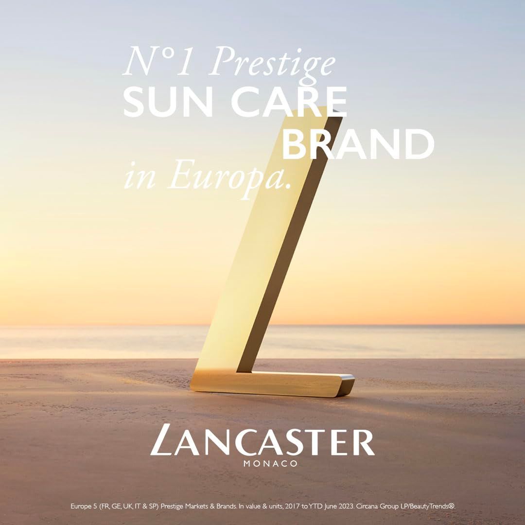 Logo L dorato sulla spiaggia. Testo: N°1 Prestige SUN CARE BRAND in Europa. Lancaster Monaco.
