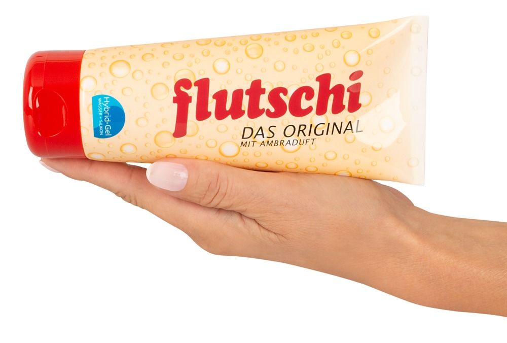 Mano che tiene un tubo Lubry Flutschi Gel Ibrido, il gel cola dal tappo aperto.