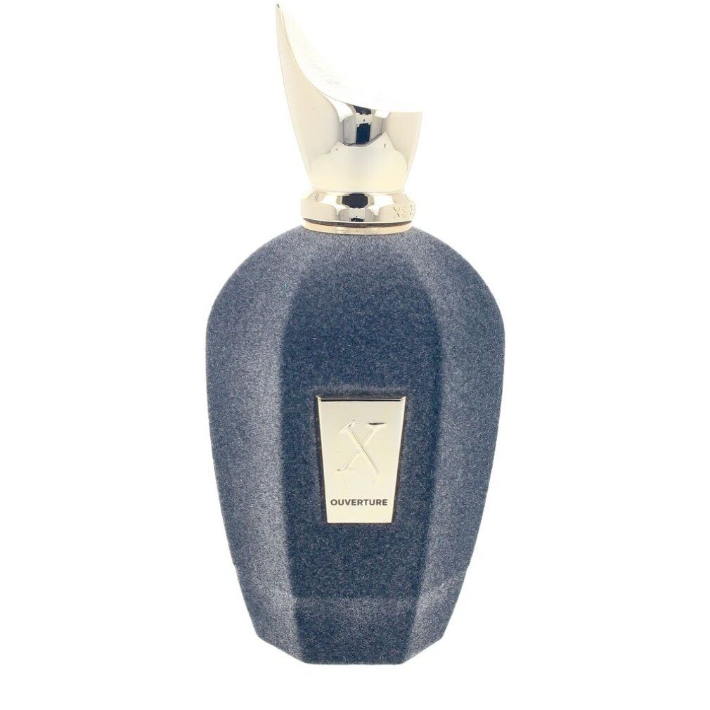 Flacone di profumo blu scuro con tappo dorato. Scritta "Ouverture" e logo.