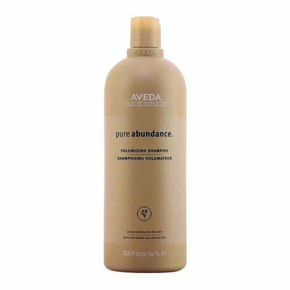 Flacone beige con logo Aveda e nome del prodotto. Testo: Pure Abundance Volumizing Shampoo. Illustrazione vegetale verde.