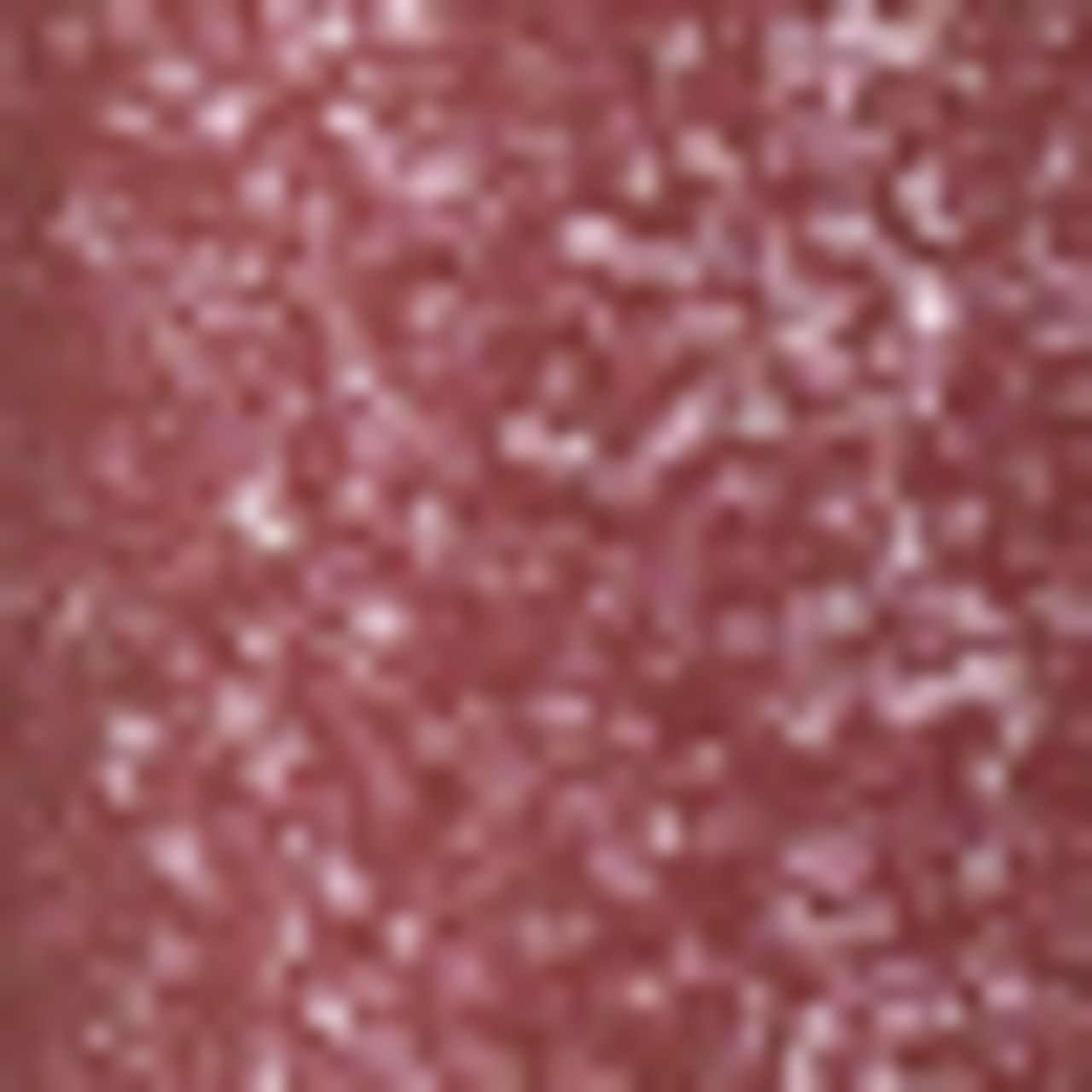 Primo piano di lucidalabbra rosa. Texture con particelle glitterate. Nessun imballaggio visibile.