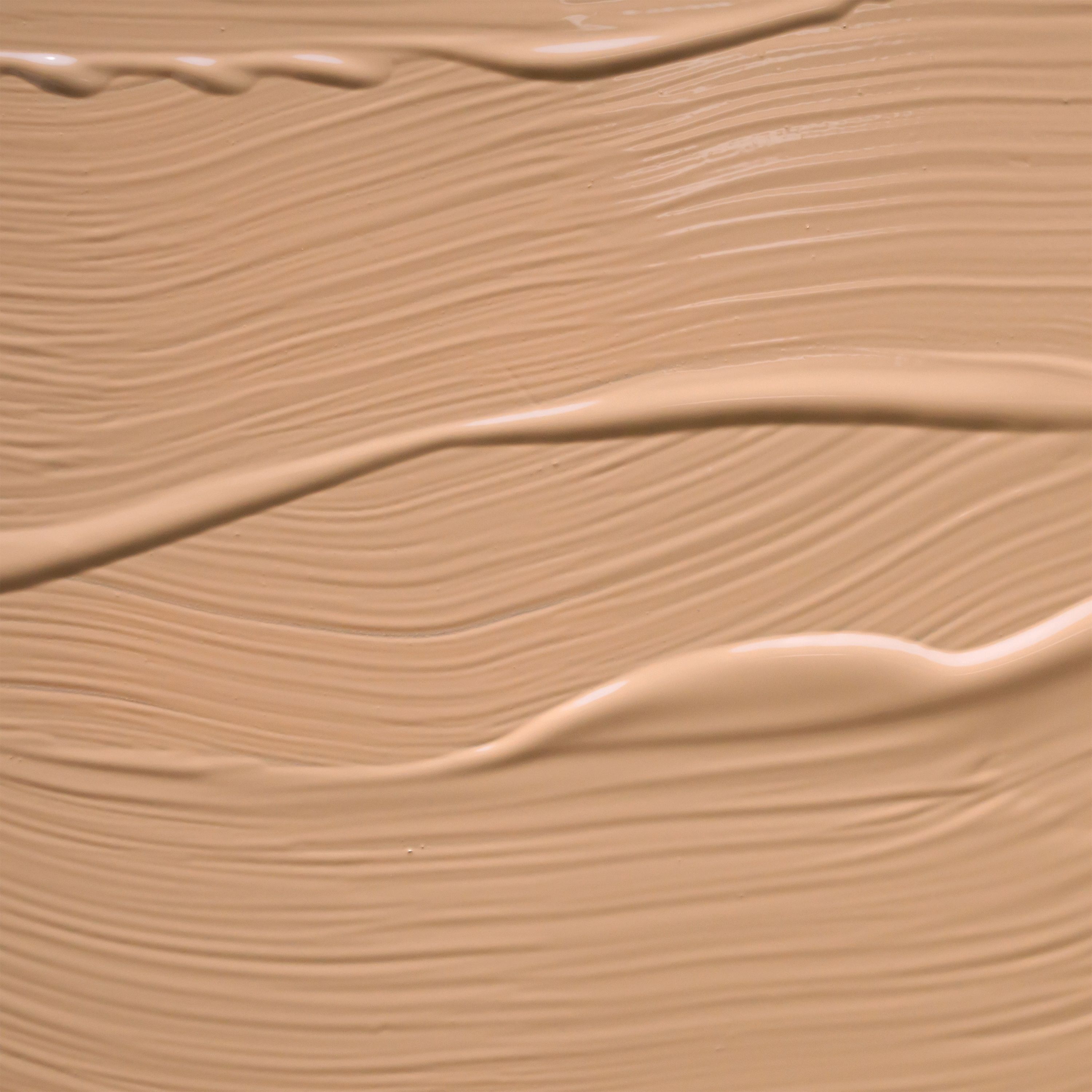 Campione di texture di una BB cream color nocciola chiaro con sottili striature di pennello.
