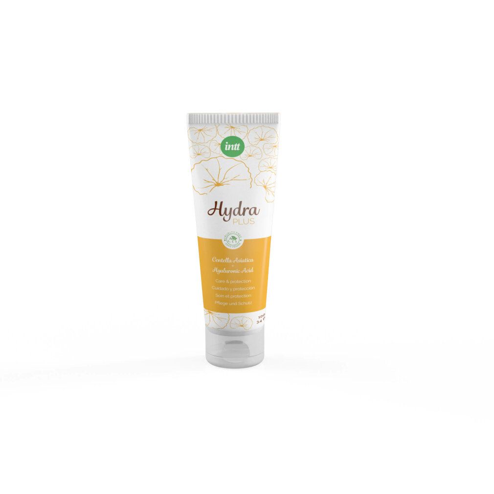 Tubo di crema con motivo floreale. Sezione centrale gialla con testo. Tappo verde con logo. Chiusura trasparente.