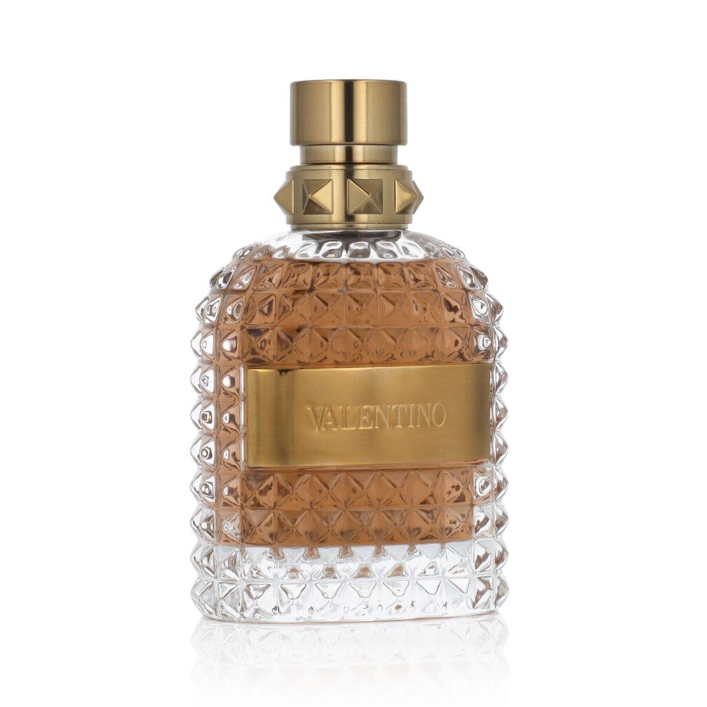 Flacone di profumo. Tappo ed etichetta dorati. Vetro sagomato.