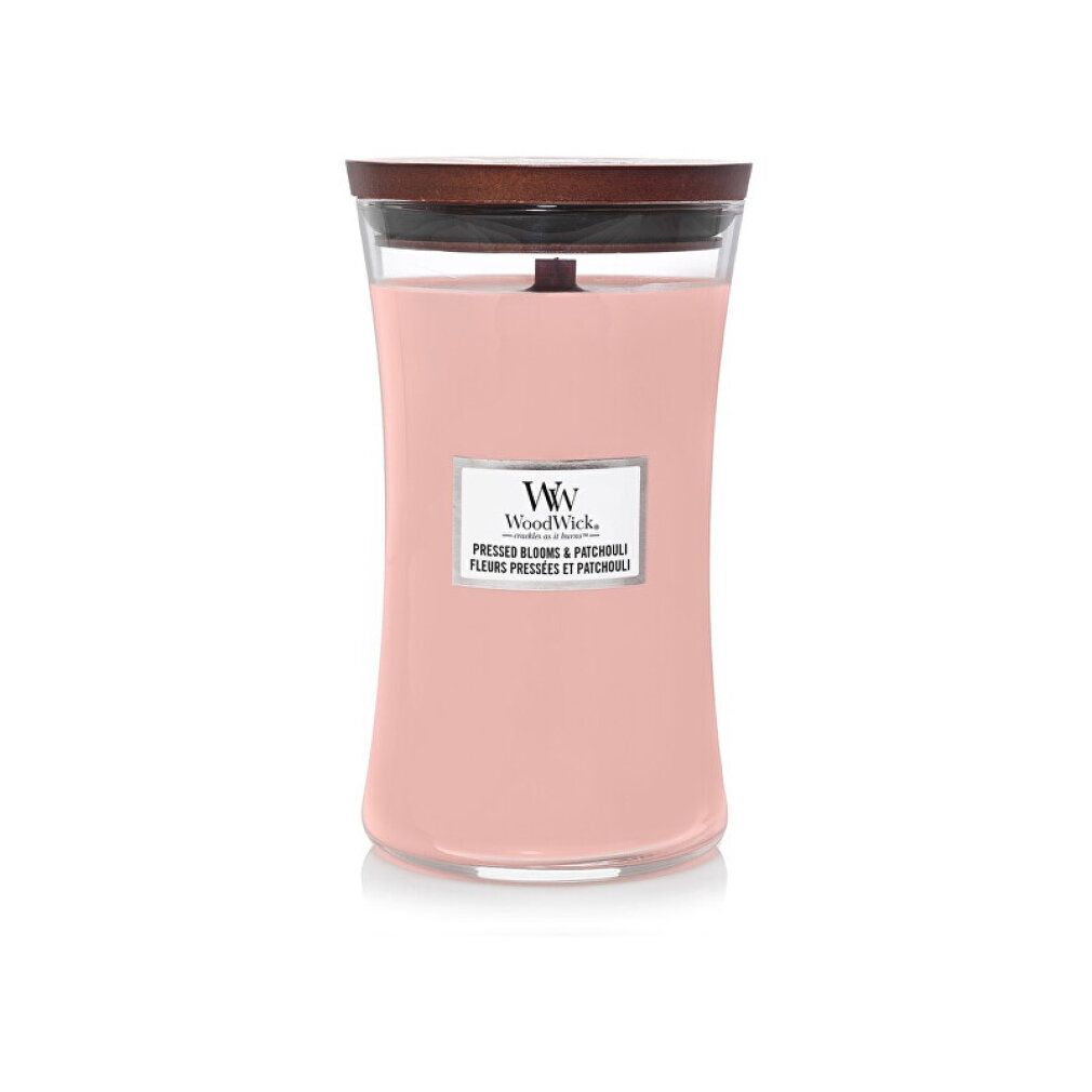 Candela profumata rosa con stoppino in legno e coperchio. Etichetta con nome del prodotto e logo. Contenitore di vetro.