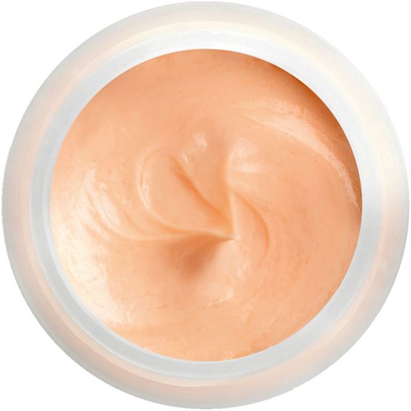 Crema in vasetto bianco rotondo. Massa color crema con consistenza visibile. Vista dall'alto.