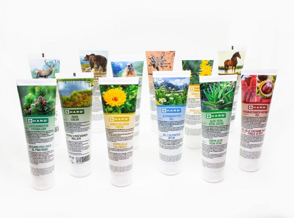 Diversi tubi di crema con immagini e nomi diversi. Logo Haro su ogni tubo. Sfondo bianco.