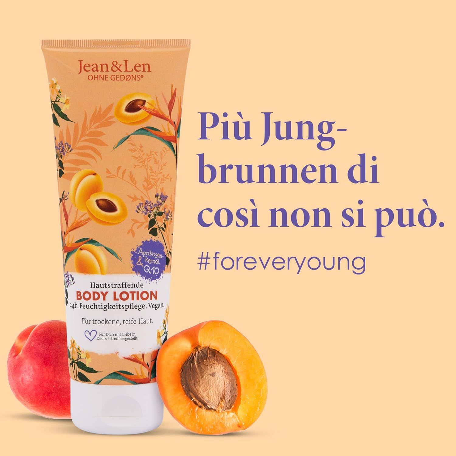 Tubo di lozione per il corpo Jean & Len con olio di nocciolo di albicocca e Q10. Albicocche e pesca accanto.