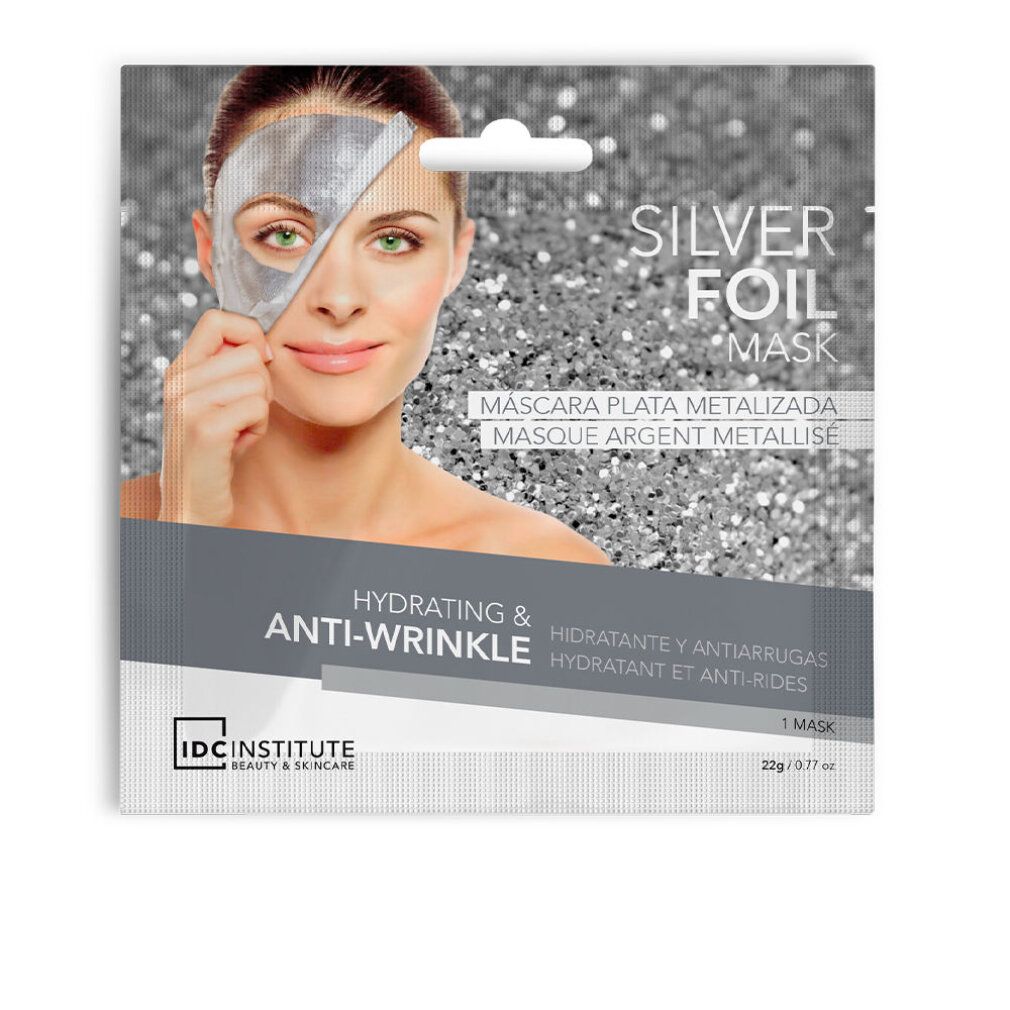 Confezione maschera in foglio d'argento. Donna con maschera. Testo: Silver Foil Mask, Hydrating & Anti-Wrinkle, IDC Institute.