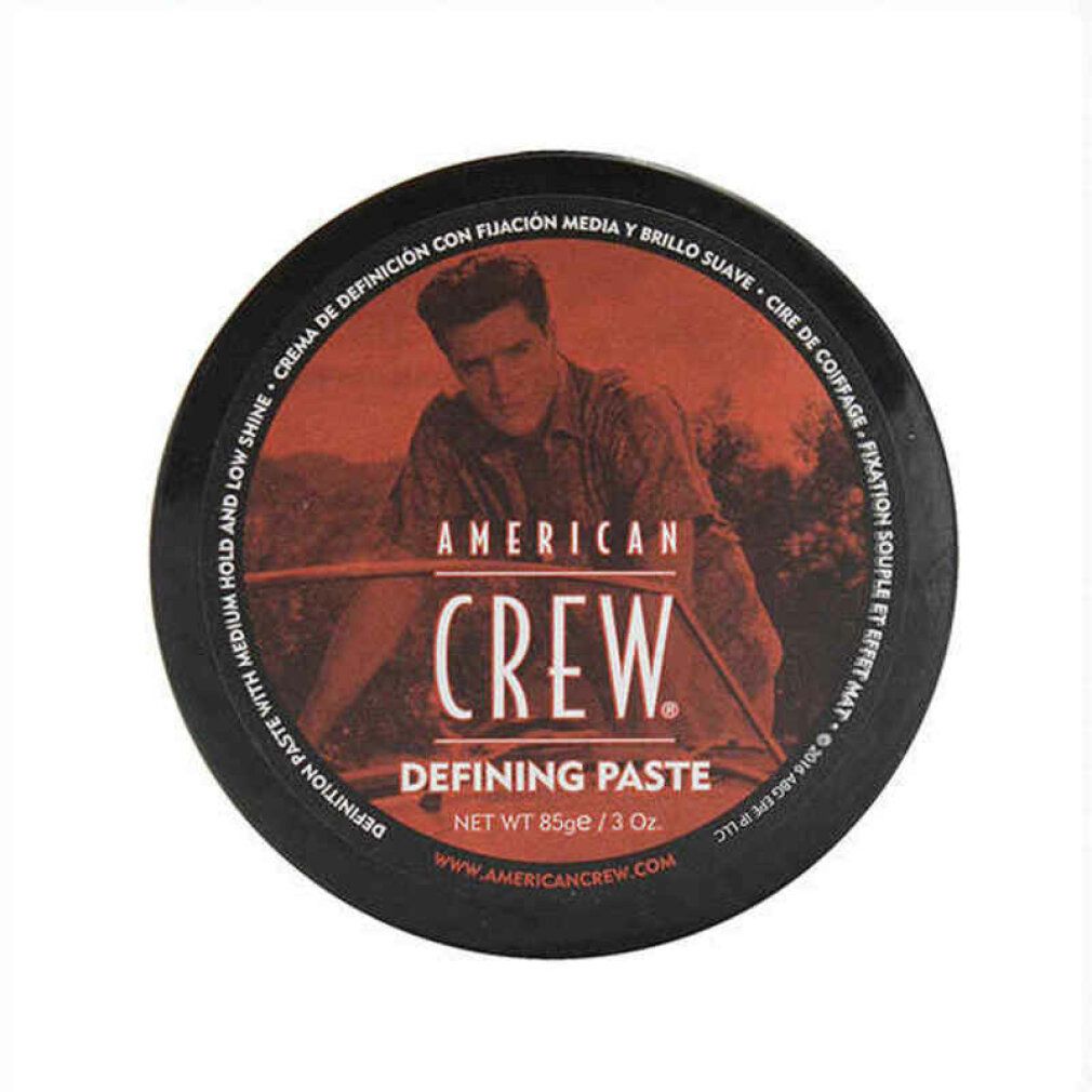 Barattolo rotondo con coperchio arancione. Bordo nero con testo e uomo. "AMERICAN CREW DEFINING PASTE" in nero. Peso netto 85g/3 Oz.