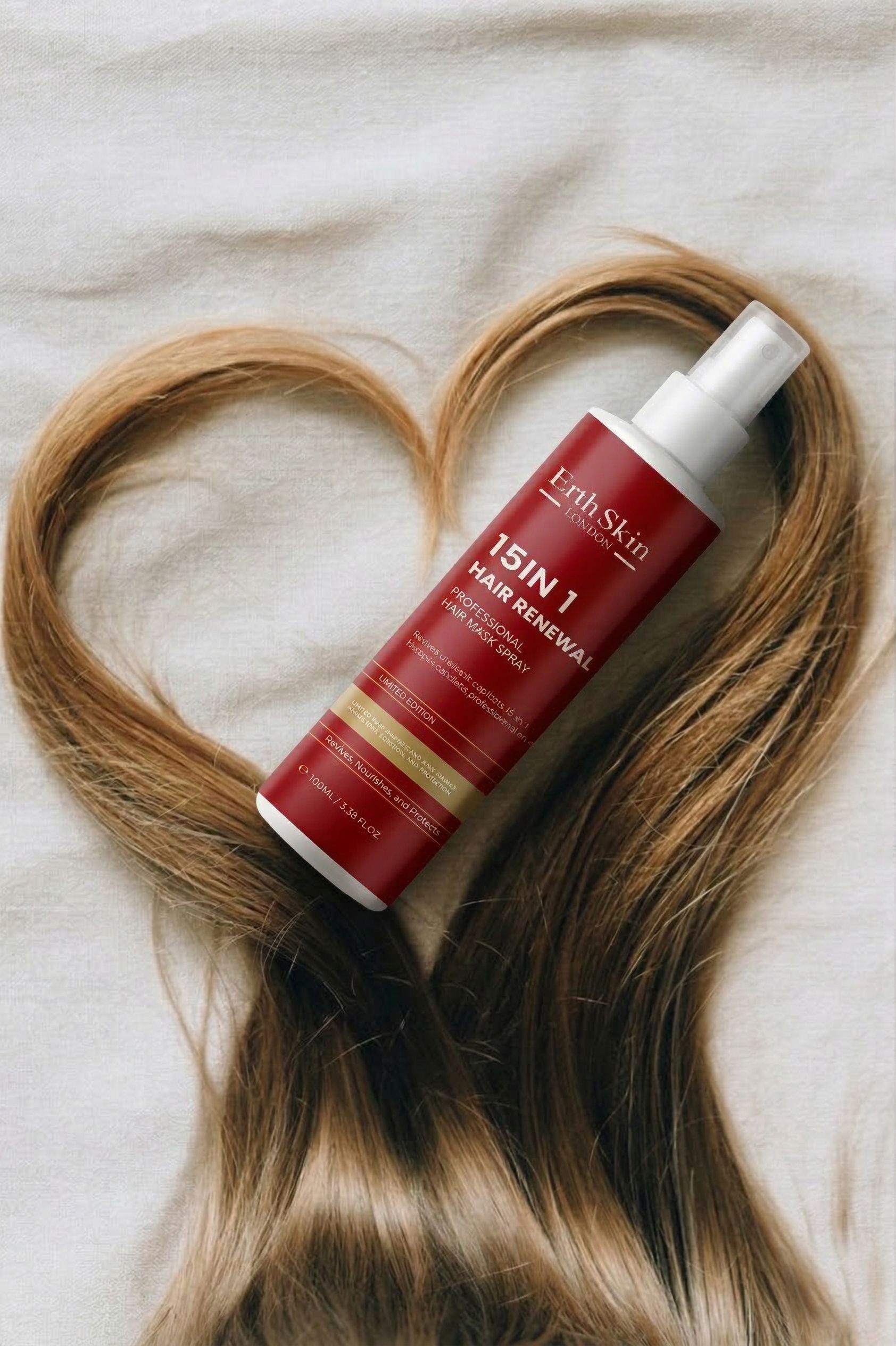ErthSkin London Spray Maschera Riparatrice Capelli 15-in-1, flacone con capelli a forma di cuore.