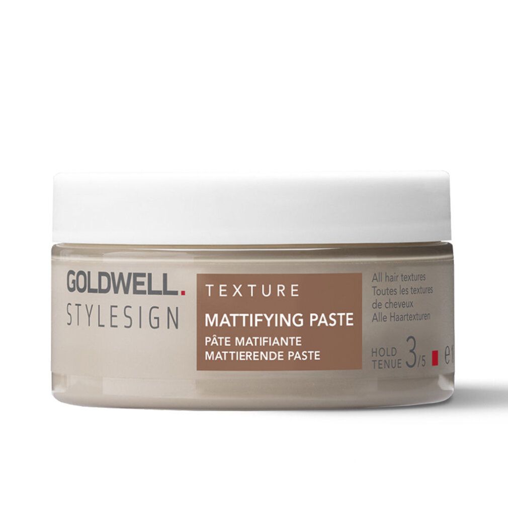 Goldwell Stylesign Texture Mattifying Paste. Barattolo beige con coperchio bianco. Nome del prodotto e marchio visibili.
