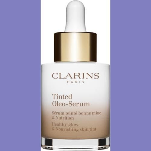 Flacone con pipetta. Scritta: Clarins Paris, Tinted Oleo-Serum. Sfumatura da bianco a marrone. Sfondo viola.