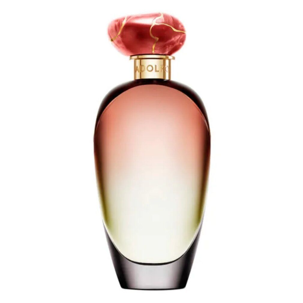 Flacone di profumo con sfumatura rosa-giallo. Tappo rosso. Collo dorato.