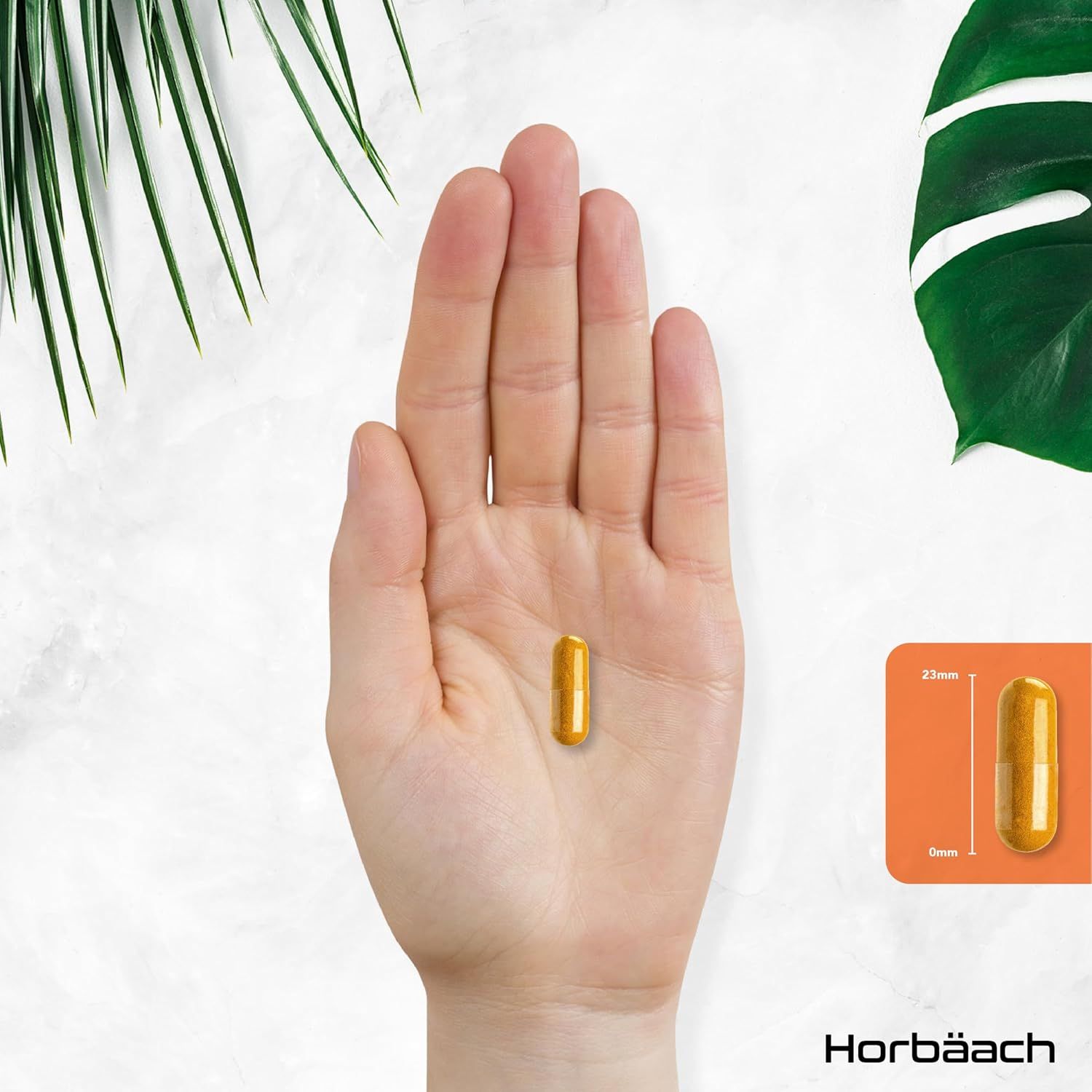 Mano che tiene una capsula gialla. Accanto, un'immagine della capsula con dimensioni: 23mm x 8mm.