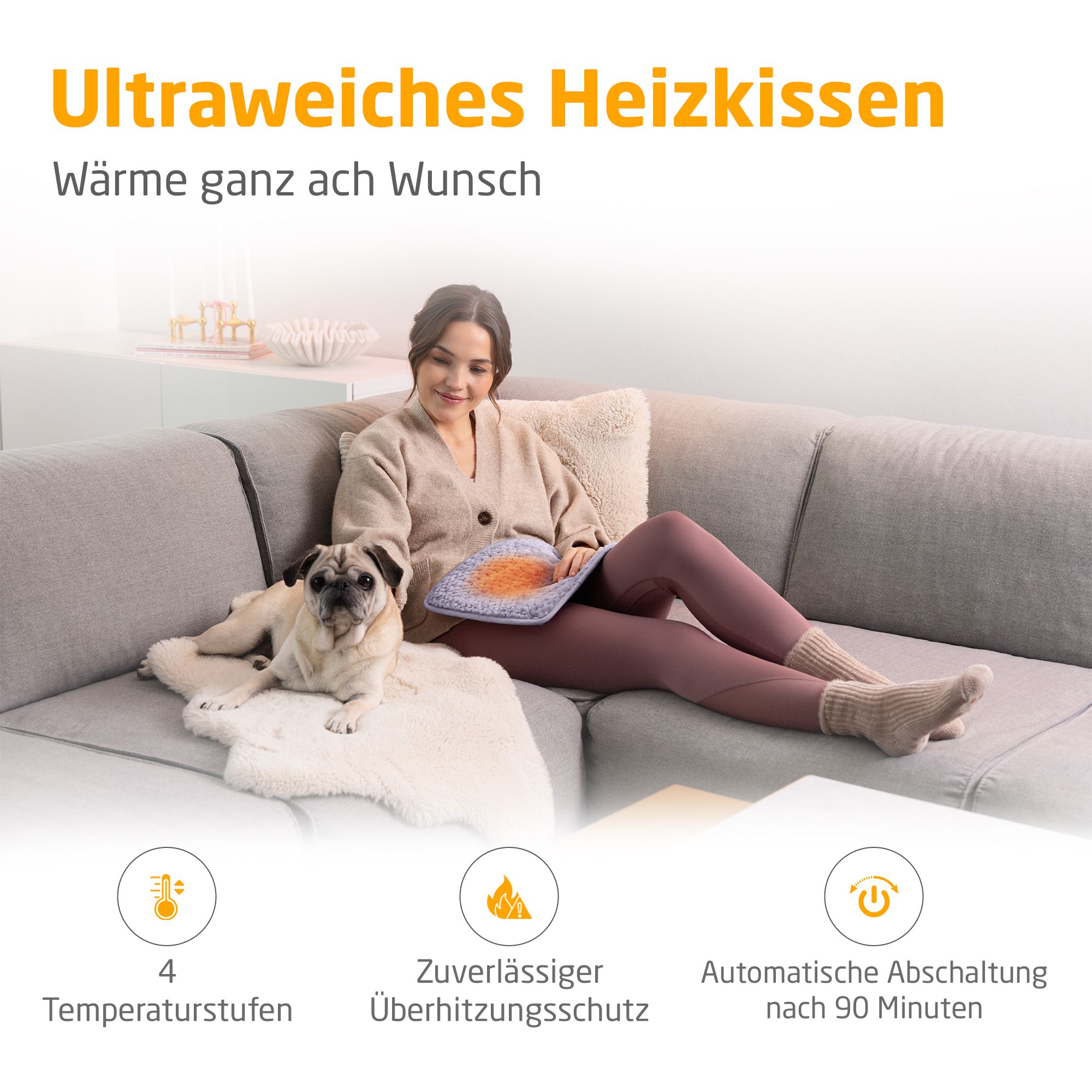 Cuscino riscaldante, lilla chiaro. Donna sul divano con cane. 4 livelli di temperatura, protezione surriscaldamento.