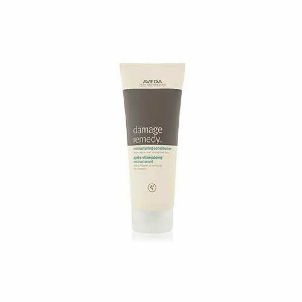 Tubo color crema con tappo grigio. Scritta: Damage Remedy Restructuring Conditioner. Marca: Aveda.