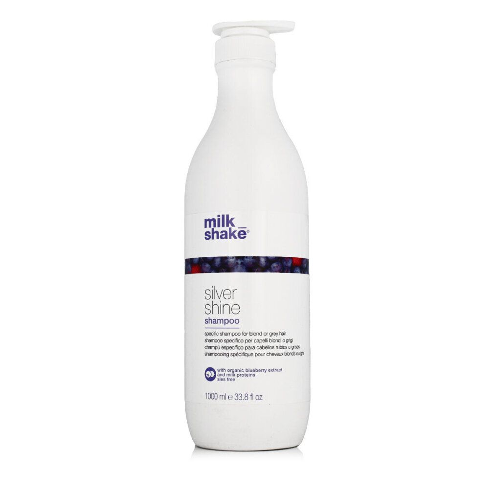 Flacone bianco con dosatore. Scritta: milk_shake Silver Shine Shampoo. Decorazione blu e rossa. 1000 ml.