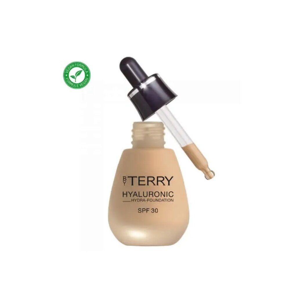 Flacone beige con pipetta. Scritta: BY TERRY, Hyaluronic Hydra-Foundation, SPF 30. Sigillo vegano.