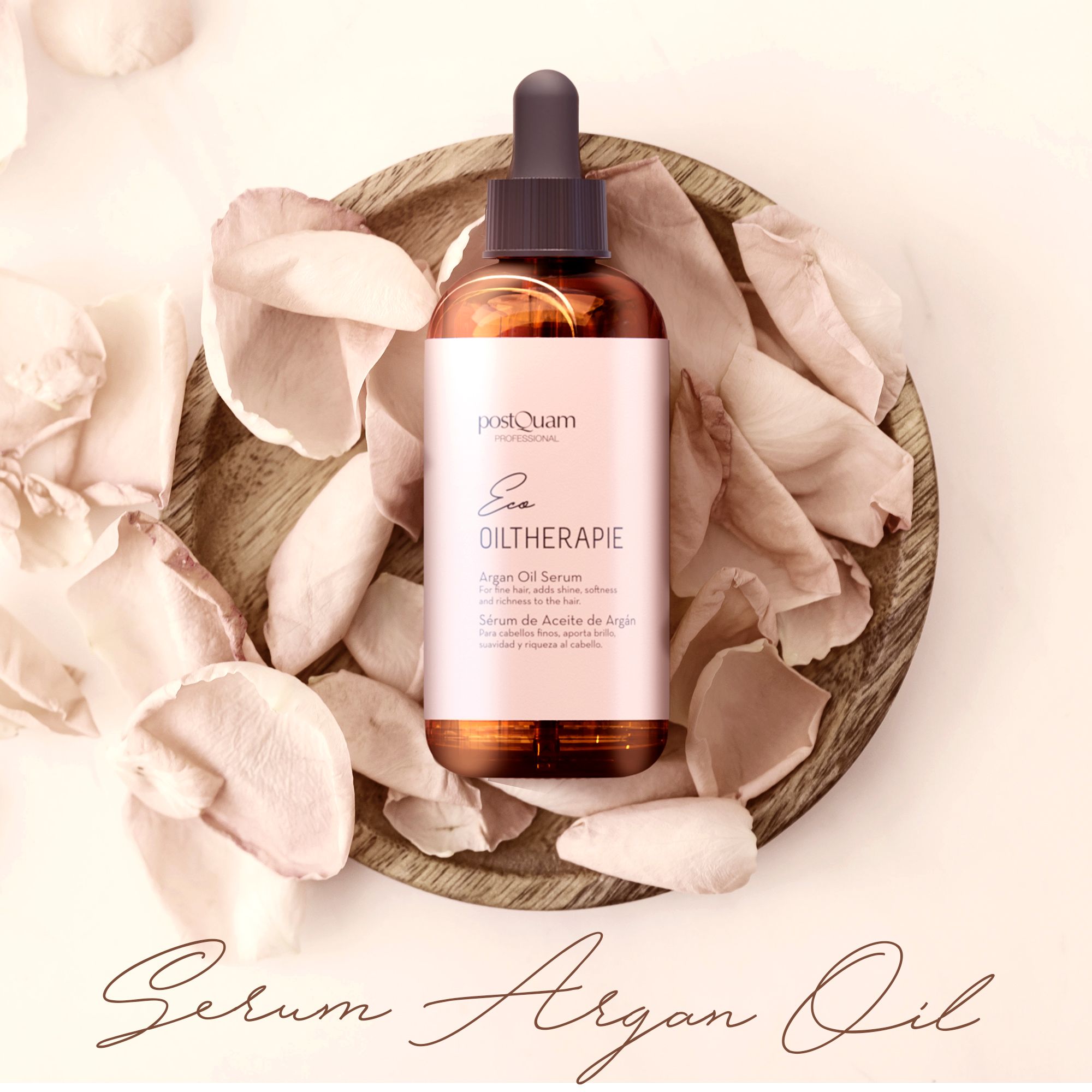 Flacone di vetro marrone con contagocce in una ciotola di legno con petali. Scritta: Eco Oiltherapie, Siero all'olio di Argan. Marchio: postQuam.