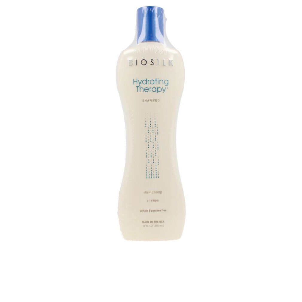 Flacone bianco con tappo blu, confezionato. Scritta: Biosilk Hydrating Therapy Shampoo. Forma verticale.