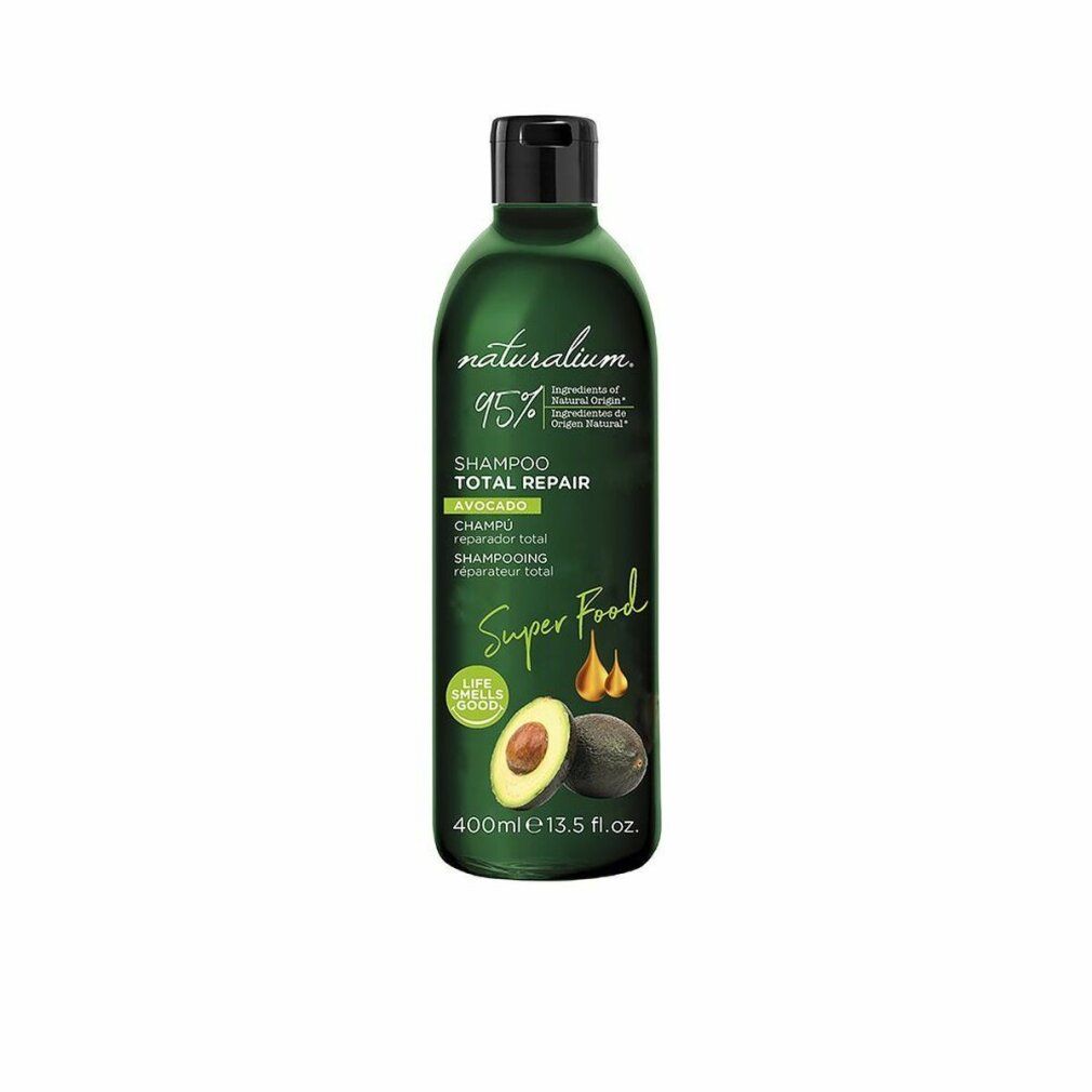Flacone di shampoo verde con tappo nero. Illustrazione di avocado e scritta 'Super Food'. Testo: 'Shampoo Total Repair'.