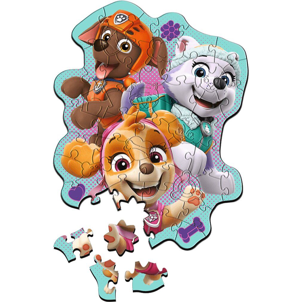 Puzzle Paw Patrol assemblato con personaggi. Alcuni pezzi sparsi. Sfondo turchese.