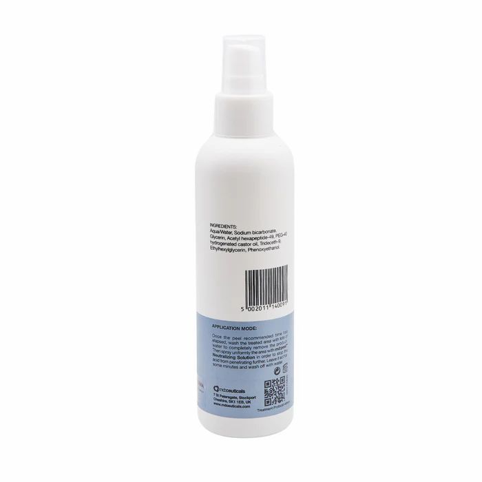 Flacone spray bianco. Etichetta con ingredienti, codice a barre e istruzioni. Striscia blu in basso.