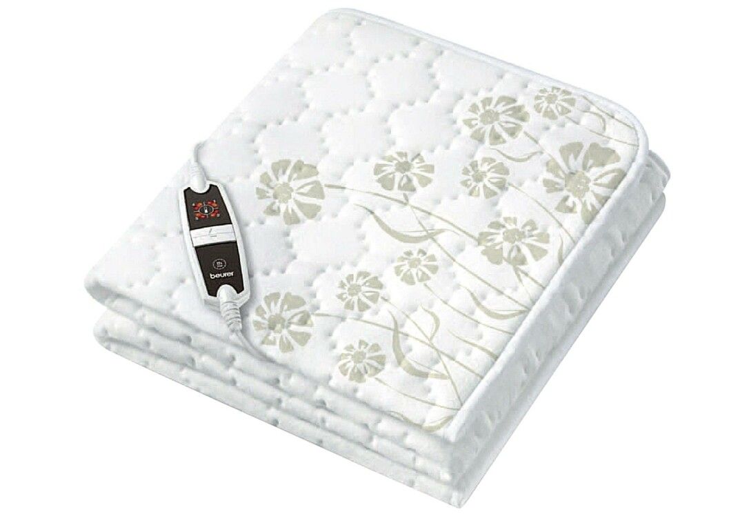 Coperta termica piegata, bianca con motivo floreale. Regolatore di temperatura nero con logo. Su sfondo bianco.