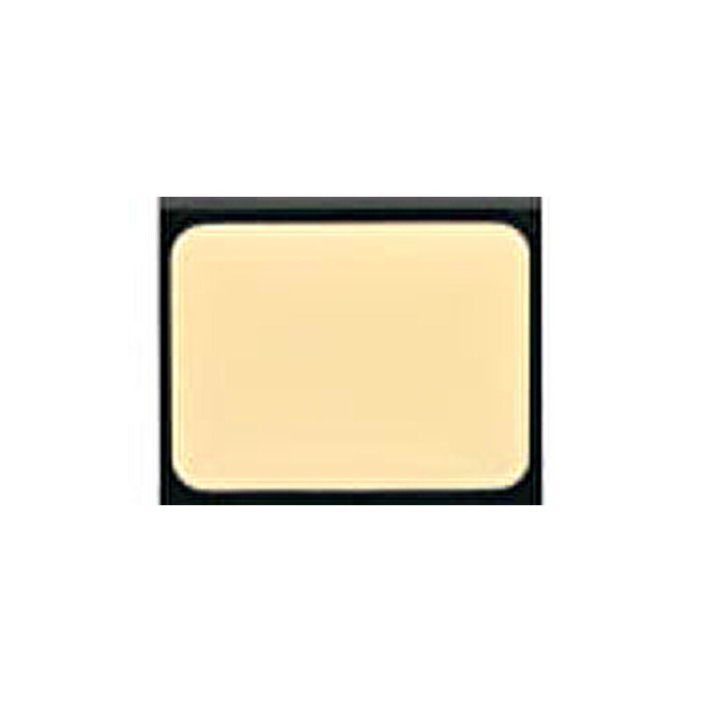 Correttore in crema camouflage rettangolare in un contenitore nero. La crema è beige chiaro.